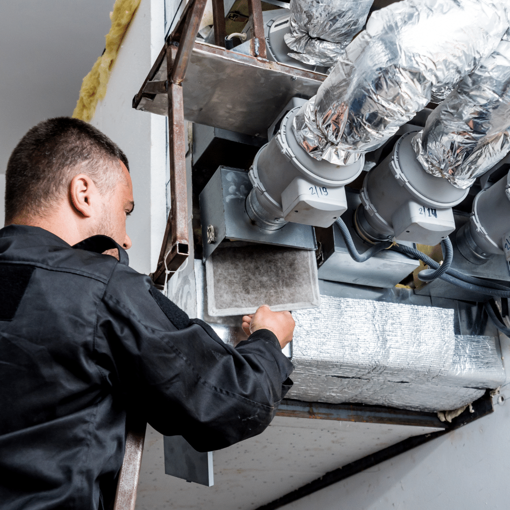 HVAC technician working on ventilation system